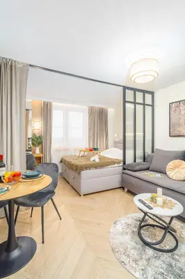 a bedroom with a bed and a table and a couch at Beautiful apartment in the city center, air conditioning, elevator in Kraków