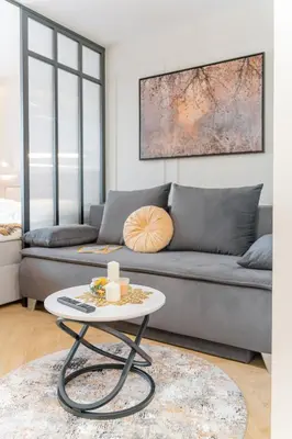 a living room with a couch and a table at Beautiful apartment in the city center, air conditioning, elevator in Kraków