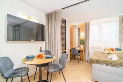 a room with a table and chairs and a bed at Beautiful apartment in the city center, air conditioning, elevator in Kraków