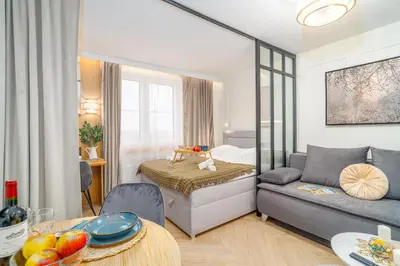 a living room with a bed and a couch at Beautiful apartment in the city center, air conditioning, elevator in Kraków