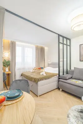 a bedroom with a bed and a couch and a table at Beautiful apartment in the city center, air conditioning, elevator in Kraków