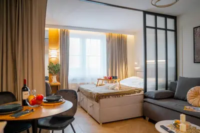 a room with a bed and a couch and a table at Beautiful apartment in the city center, air conditioning, elevator in Kraków