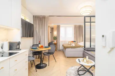 a kitchen and living room with a table and chairs at Beautiful apartment in the city center, air conditioning, elevator in Kraków
