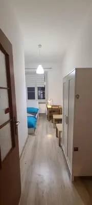 a room with a hallway with chairs and a table at Centrally located cozy apartment in Kraków