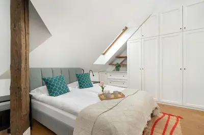 a bedroom with a bed with blue pillows at Modern Apartment with Air Conditioning and Terrace near Old Town in Cracow by Noclegi Renters in Kraków