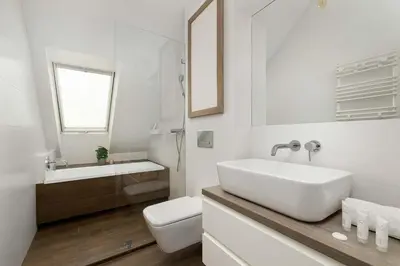 a white bathroom with a sink and a toilet at Modern Apartment with Air Conditioning and Terrace near Old Town in Cracow by Noclegi Renters in Kraków