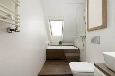 a white bathroom with a sink and a toilet at Modern Apartment with Air Conditioning and Terrace near Old Town in Cracow by Noclegi Renters in Kraków