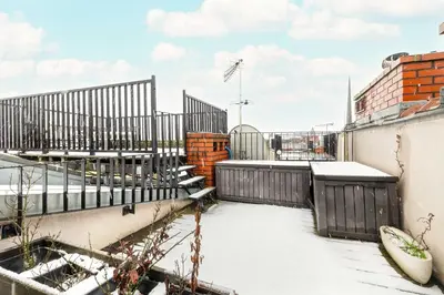 a balcony with snow on the roof of a building at Modern Apartment with Air Conditioning and Terrace near Old Town in Cracow by Noclegi Renters in Kraków