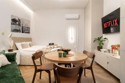 a living room with a table and a couch at Malila Premium Apartments Estery Boutique in Kraków