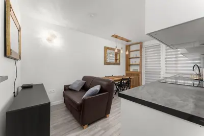 a living room with a couch and a table at Bronowice Spacious Apartment by BookingHost in Kraków