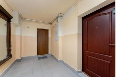 a hallway with a wooden door and a hallway sidx sidx at Bronowice Spacious Apartment by BookingHost in Kraków
