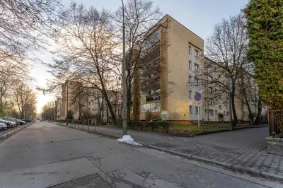 an empty street in front of a building at Bronowice Spacious Apartment by BookingHost in Kraków