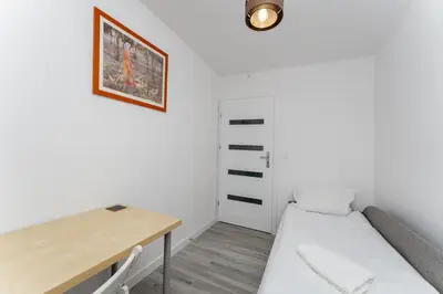 a small room with a desk and a bed at Bronowice Spacious Apartment by BookingHost in Kraków