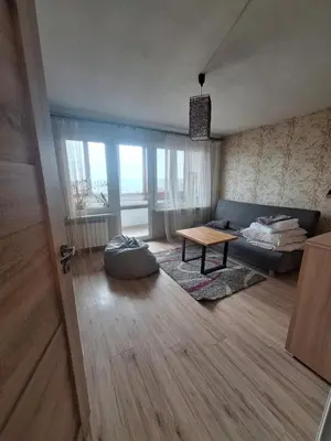 a living room with a couch and a table at Sky View Cracow Apartment in Kraków
