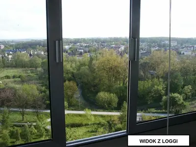 a small room with a couch and a window at Sky View Cracow Apartment in Kraków
