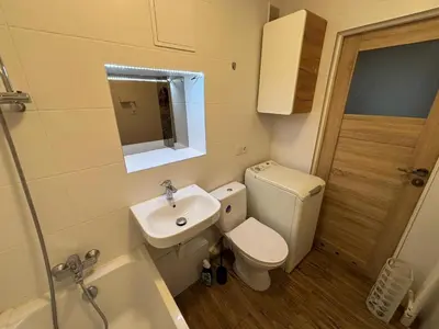 a bathroom with a sink and a toilet and a shower at Sky View Cracow Apartment in Kraków