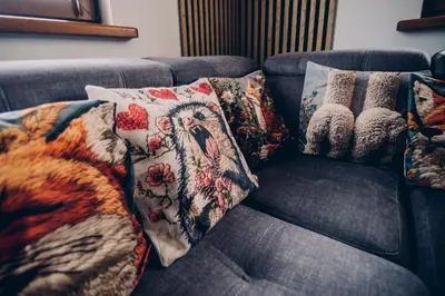 a blue couch with pillows on it at Zacisze Krzeszów in Krzeszów