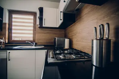 a small kitchen with a stove and a sink at Zacisze Krzeszów in Krzeszów