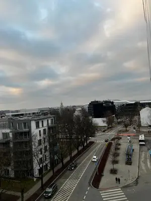 a view of a city street with cars and buildings at Small Apartment in Kraków