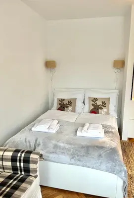 a bedroom with a white bed with two towels on it at Studio Krowodrza Centrum in Kraków