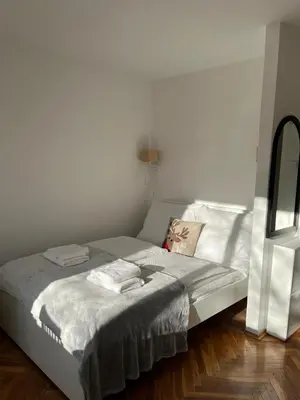 a bed with two towels on it in a room at Studio Krowodrza Centrum in Kraków