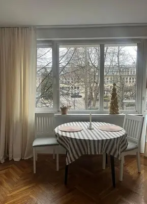 a table and two chairs in a room with a window at Studio Krowodrza Centrum in Kraków