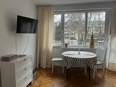 a living room with a table and a window at Studio Krowodrza Centrum in Kraków
