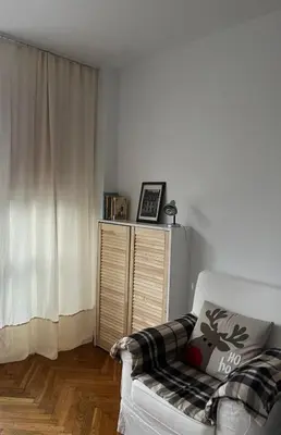 a living room with a white couch and a window at Studio Krowodrza Centrum in Kraków