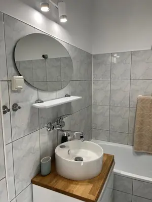a bathroom with a sink and a mirror at Studio Krowodrza Centrum in Kraków