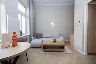 a living room with a couch and a table at Modern apartment -Berka Joselewicza 5 street in Kraków