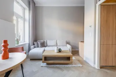 a living room with a couch and a coffee table at Modern apartment -Berka Joselewicza 5 street in Kraków