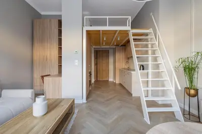 a living room with a loft bed and a staircase at Modern apartment -Berka Joselewicza 5 street in Kraków