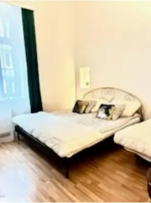 a bedroom with two beds in a room at Jubilat Apartament in Kraków