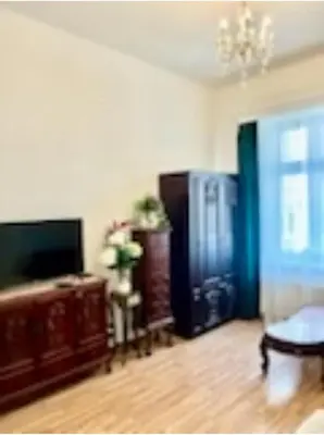 a living room with a flat screen tv and a couch at Jubilat Apartament in Kraków