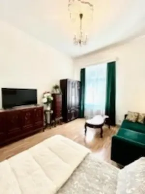 a living room with a couch and a tv at Jubilat Apartament in Kraków