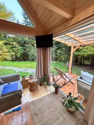 a picnic table in the middle of a forest at Tiny house nad potokiem in Ohłypów