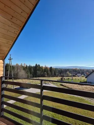 a fence with a view of a train station at Domek Pod Babim Szczytem in Zubrzyca Górna