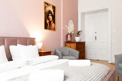 a bedroom with a bed and a chair at Househost Apartment Zacisze 16 in Kraków