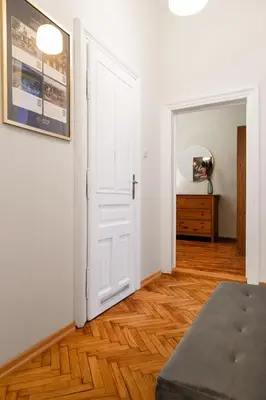 a room with a white door and a wooden floor at Househost Apartment Zacisze 16 in Kraków