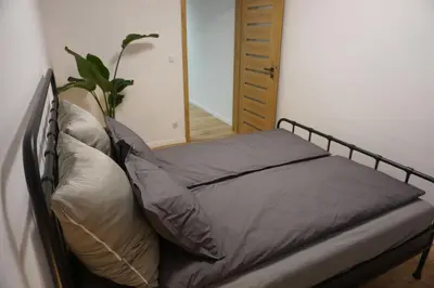 a bed with pillows on it in a bedroom at VIP Apartments Victoria in Wieliczka