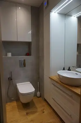 a bathroom with a sink and a toilet and a mirror at VIP Apartments Victoria in Wieliczka