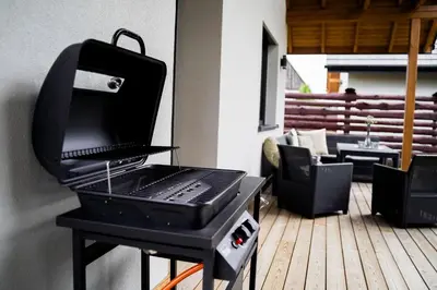 a grill sitting on top of a deck at Domki Natura Zator in Graboszyce