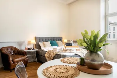 a living room with a couch and a table at Malila Premium Apartments Szczepański Square in Kraków