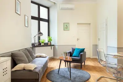 a living room with a couch and a table at Malila Premium Apartments Szczepański Square in Kraków
