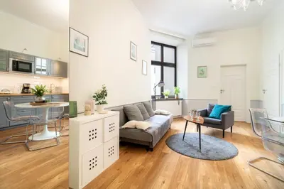 a living room with a couch and a table at Malila Premium Apartments Szczepański Square in Kraków