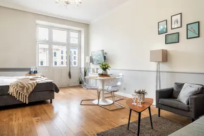a living room with a bed and a couch and a table at Malila Premium Apartments Szczepański Square in Kraków