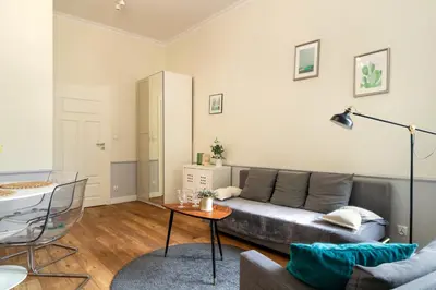 a living room with a couch and a table at Malila Premium Apartments Szczepański Square in Kraków