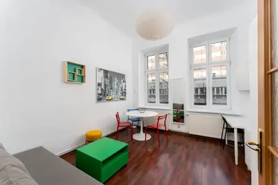 a room with a bed and a table and chairs at Cracow City Centre Apartment by BookingHost in Kraków