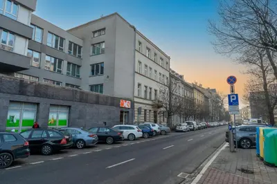 a living room with a couch and a table and chairs at Cracow City Centre Apartment by BookingHost in Kraków