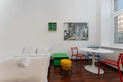 a room with a table and chairs and windows at Cracow City Centre Apartment by BookingHost in Kraków